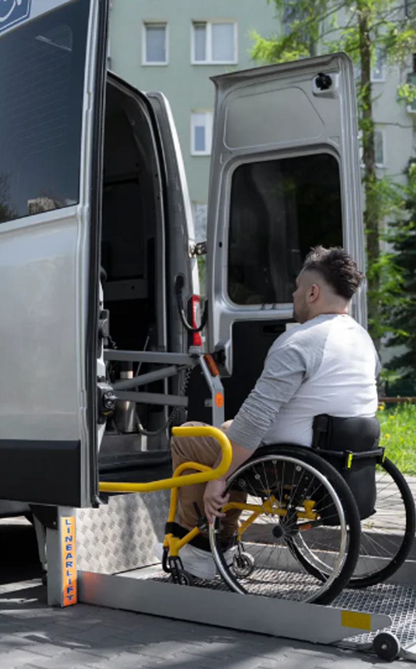Elite Transportation van loading a patient in wheelchair via wheelchair lift